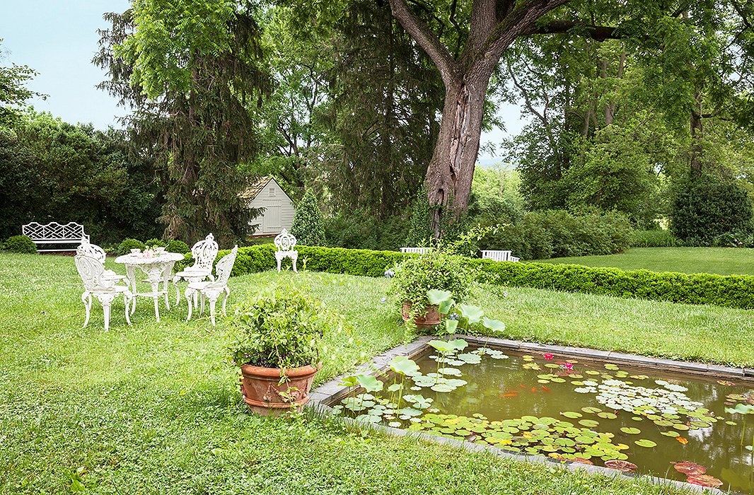 A moment of rural peace is elevated by a lily pool, with elegant seating to take in the views.
