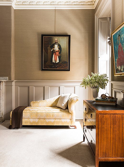 In a corner of the master bedroom sits Nina’s most prized possession. “The chaise is actually the first piece of furniture that I ever bought on my own after college,” says Nina of the Fendi piece, which she reupholstered in a yellow-stitch fabric. “It’s traveled with me all this time.” The vintage painting of a maharaja is from Jaipur, India.
