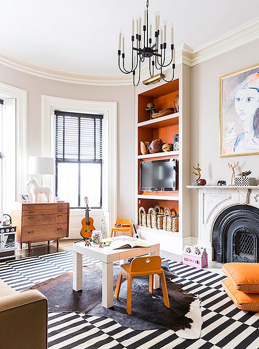 Open floor space is key in a family room when you’ve got little ones running around. Layer on rugs and cushy floor pillows to create plenty of soft landing spots. Photo by Aubrie Pick.
