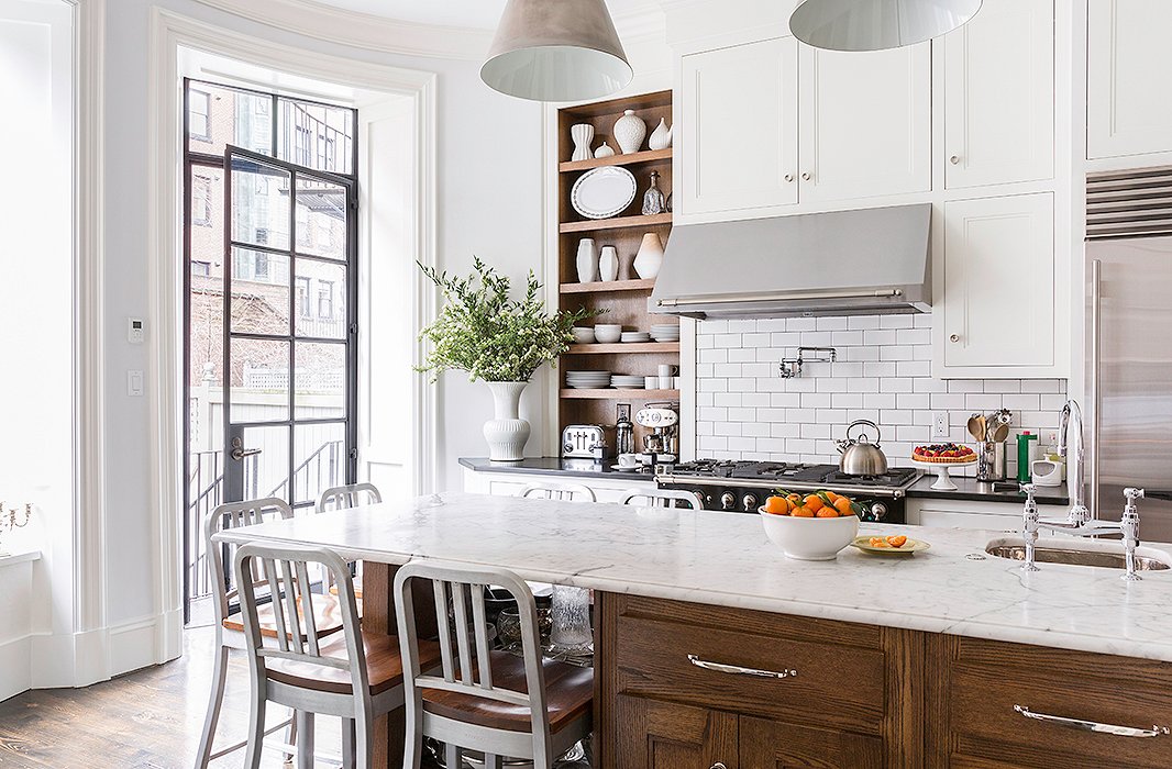 Everyday meals occur around the kitchen’s marble island counter surrounded with Emeco barstools. “Everything happens here!” laughs Nina. “We don’t get to cook long gourmet dinners every night, but when I get the chance I love to.” The range is La Cornue, and the vent hood is Best by Broan.
