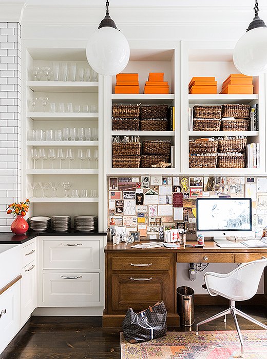 “I like keeping an eye on what’s happening in the house yet having my own space off the kitchen,” says Nina of her built-in office area, organized with fabric swatches, paint chips, and inspirations.
 
