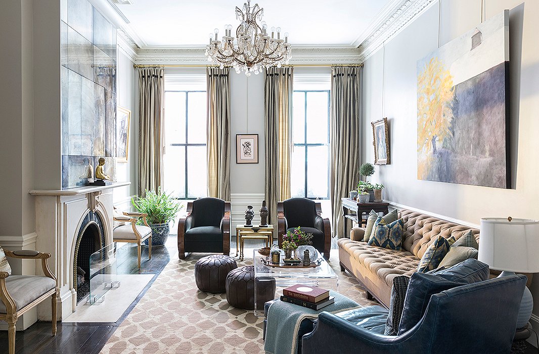 The living room, with a pair of French Art Deco chairs and a long tufted sofa, is the “catchall room” and the site of family time and game-day hosting (there’s a TV cleverly hidden behind the antique mirror above the mantel). “I wanted it to feel elegant enough to hold its own in this old beautiful brownstone but then be family-friendly and approachable enough,” Nina says.
