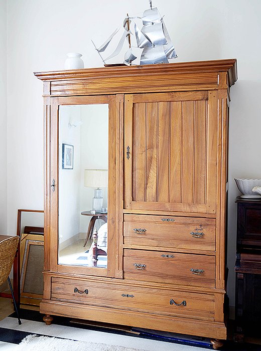 On top of the guest room armoire, Peter perched an aluminum boat that he and his partner found at a junk shop.
