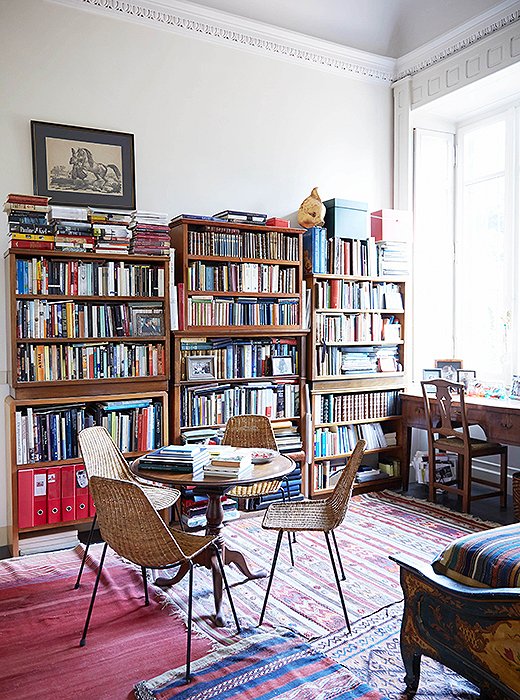 One of the layered rugs was the first thing Peter ever bought with his own money, during a trip to Turkey’s Aegean coast when he was 14. The rattan café chairs from the 1950s are paired with an 18th-century table from his parents.
 
