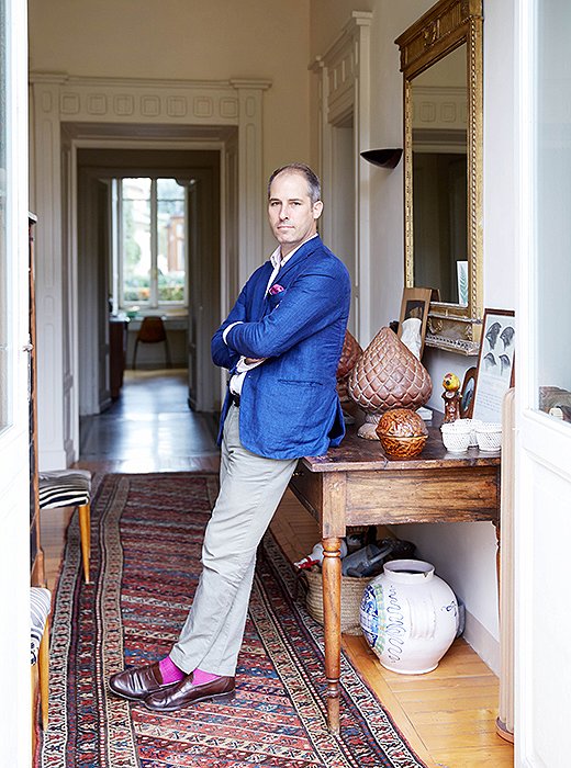 Peter leans opposite his favorite pieces—a pair of 1950s Italian zebra-stripe chairs.
