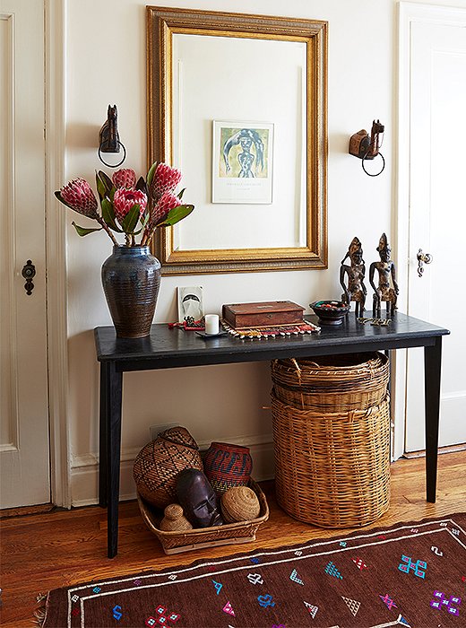 African sculptures grace the entry’s console table, beneath which sit baskets collected from near and far. “I’ve always kept my savings for travel,” Hardison says. “Travel is important.”
