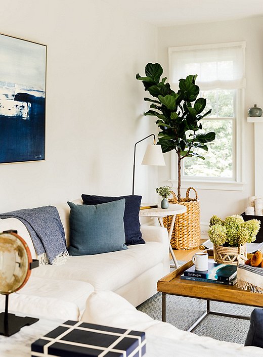 Chauncey went with layered neutrals and touches of blue in the family room. Woven jute elements throughout the room punch up the texture and modern vibe.
