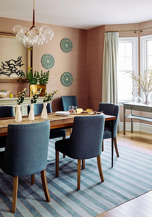 “I wanted to find a color that could hold its own,” says Chauncey of her choice to go pink in the dining room. The grass-cloth wallpaper adds color with subtle elegance. The decorative bowls serve as wall art loaded with texture.
