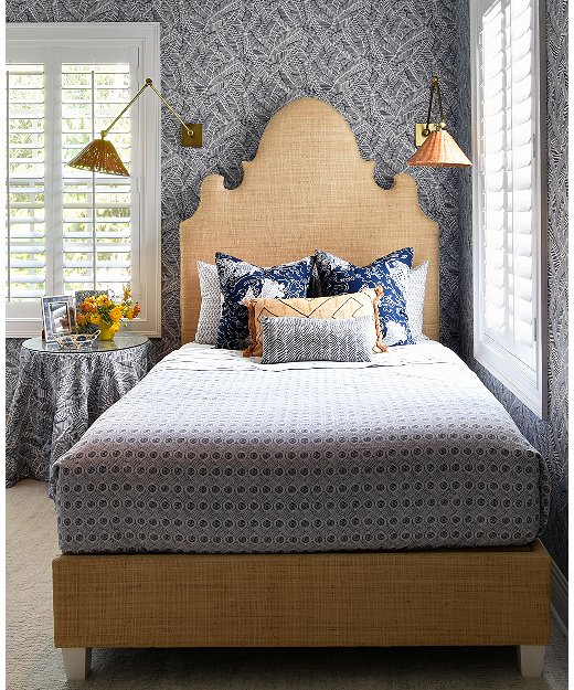 Caroline turned this small guest room in to a jewel-box space by going bold with the wallpaper and textures. 
