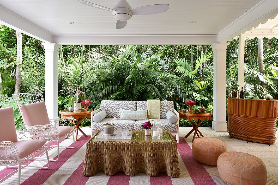 “This area is an extension of their home; they really live out there,” says Caroline of the home’s loggia. With performance fabric and outdoor-approved furnishings, Caroline was able to create a colorful escape. The outdoor spaces came to life with the help of landscape architect Fernando Wong. “He really took this house and made it so charming,” says Caroline. 
