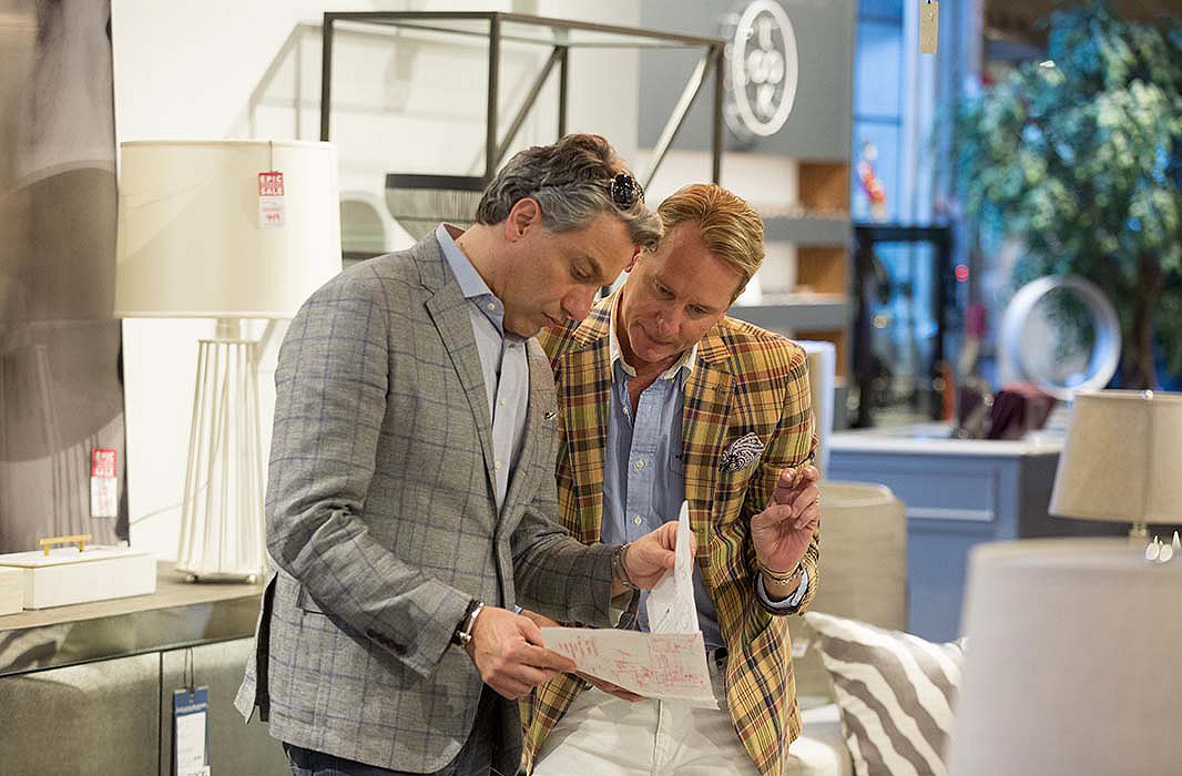 Thom Filicia and Carson Kressley. Above: A room designed by Thom and Carson features a round dining table, cleverly placed books, and artwork from Lillian August.
