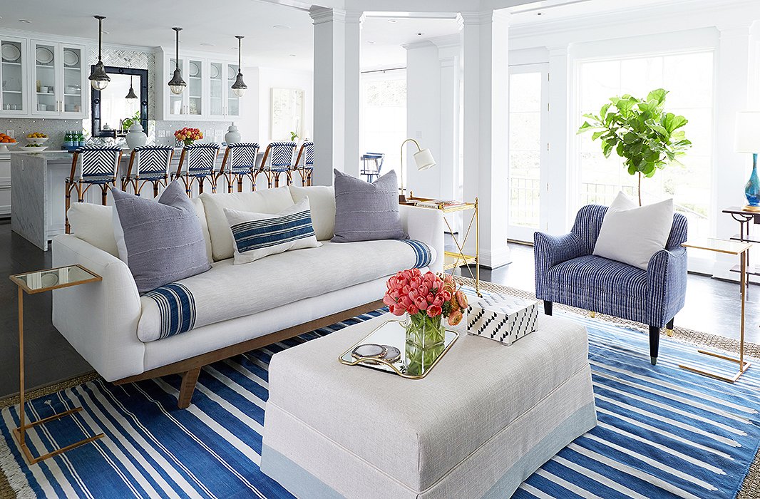 The custom-sized throw, wrapped around both sides of the seat cushion, protects the couch with a “washable barrier,” as Cassie puts it, for any spills. The cushions add more layers of washable fabric and ramp up the easy, colorful style.
