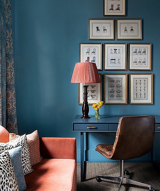 Vintage furniture prints were sourced by the client. Moody blue paint gave the office a jewel-box effect, fostering a cozy and contemplative atmosphere.

