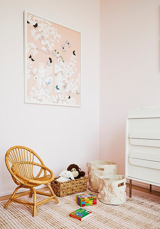 Dawn Wolfe butterfly art takes center stage in the nursery. Storage baskets from Pehr keep toys organized without taking too much space, and, because they’re canvas, they can easily be tucked away when not in use.
