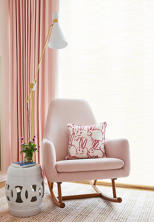The Amelia Garden Stool is a nice substitute for a side table in a small space. Christina also went with a slim floor lamp to minimize visual clutter. Find similar pillows here. 
