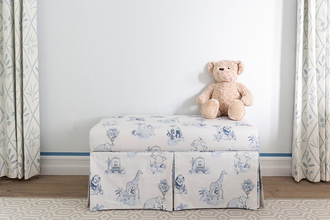 The Malin Toile print, seen here in blue on a storage bench (it also comes in pink), is a favorite of Gray’s. “It feels both elevated and playful and is very much the vibe of my twins’ nurseries,” he says. 
