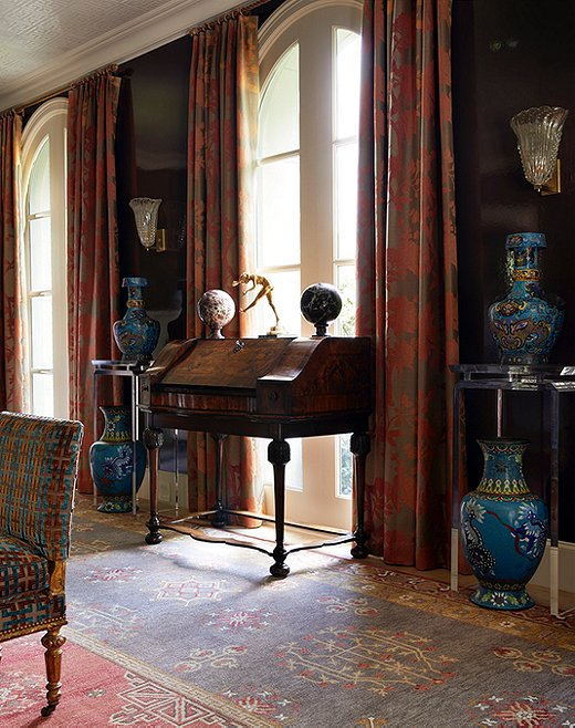 The formal sitting area is a mélange of texture and style. The traditional secretary pairs seamlessly with the large-scale chinoiserie vases.  
