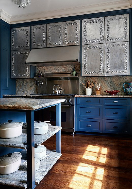 The kitchen is a maximalist’s dream. The silver repoussé cabinetry features a unique floral design. “Although I would love to take credit, these were actually left in the house by the previous homeowner,” says Dennis. “I can take credit, however, for insisting that they remain.”
