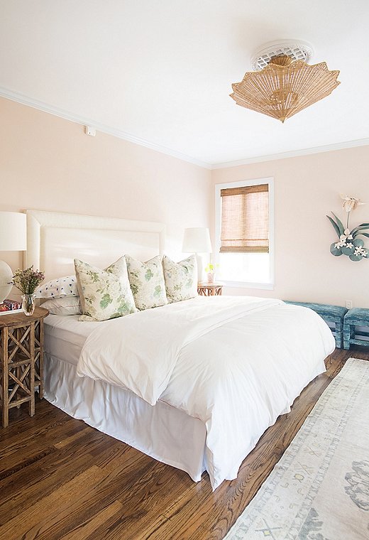 Courtland first saw this color scheme in a friend’s house and had to try it. She paired the blush walls with natural elements, such as the rattan Celerie Kemble for Arteriors ceiling fixture. Find a similar headboard here.
