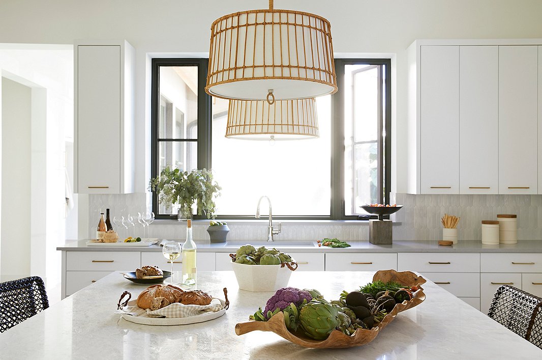With her Sea Island pendant, Beth pairs earthy (and eco-friendly) rattan with refined linen. More textural contrasts come courtesy of the Taylor tray and centerpiece, in which woven leather handles offset the crackled ceramic glaze.
