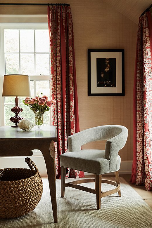 The red curtains in the office add jolt of color to an otherwise subdued palette.
