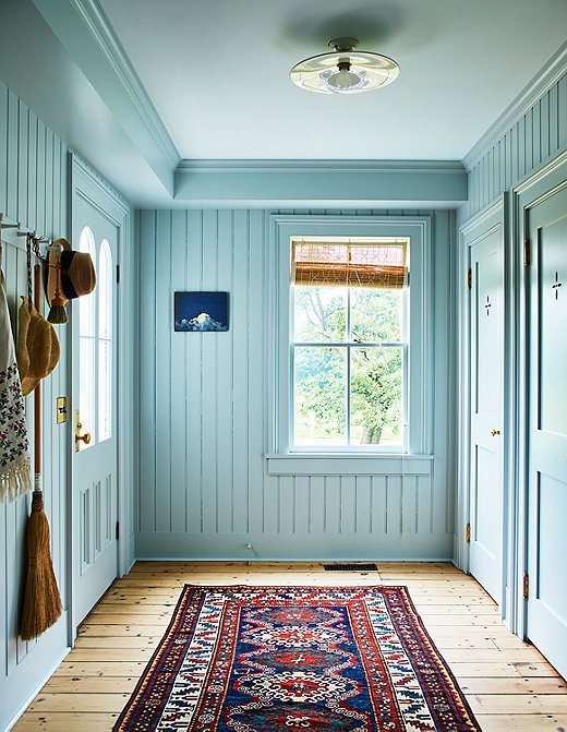 Farrow & Ball’s Skylight sets the tone for this pass-through area. Teamed with an intricate runner and light wooden floors, the wall color feels bright and happy. 
