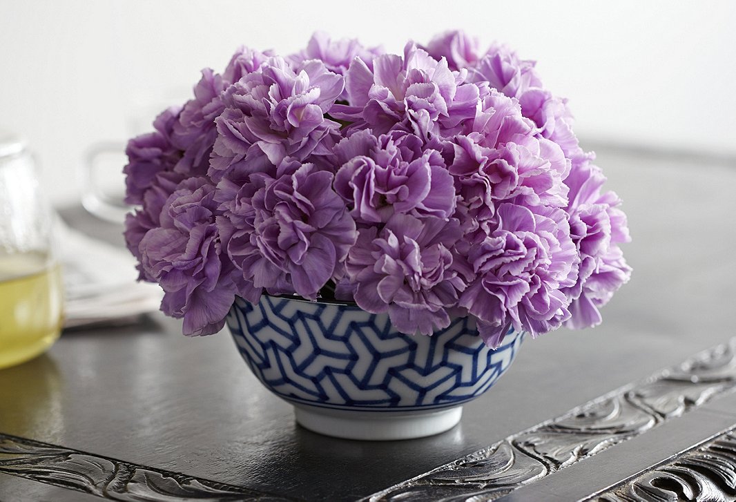 The easiest way to arrange carnations: Place the most voluptuous bloom in the center and bunch all of them together as tightly as possible. Sticking with one color and a relatively simple vessel gives them a luxe appeal.
