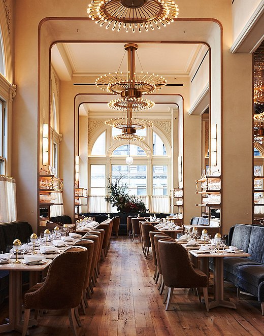 The dining room of Verōnika is bright and airy with high ceilings and large windows.
