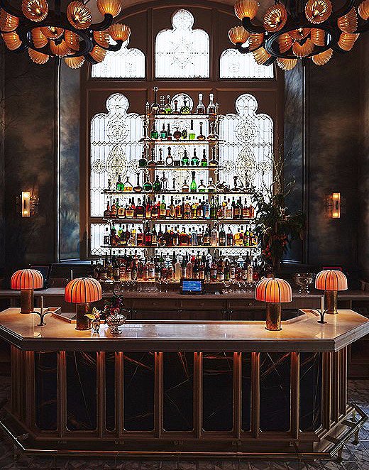 As a foil to the bright dining room, the adjacent bar is darker and reminiscent of an Old World salon as seen in a vintage photograph.
