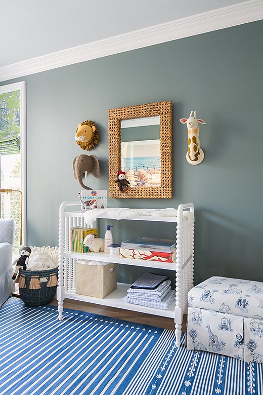 The Malin Toile Storage Bench, seen here in Gray’s son’s room, provides a soft spot to sit and a sneaky space to stow away blankets and toys. 
