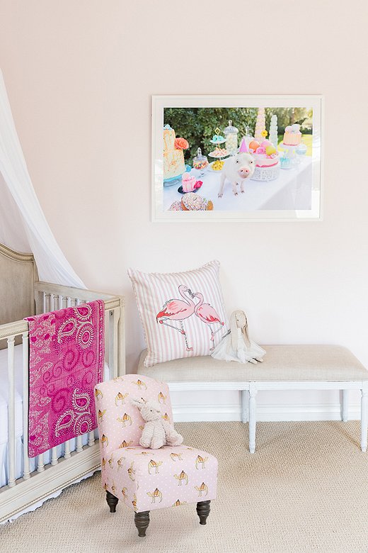 The Flamingo Stripe Pillow and the kid-size Camel Dot Chair (both shown in pink) make a sweet pairing in Gray’s daughter’s room. 
