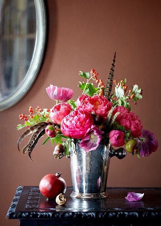 If you manage to score peonies in their off-season, try pairing them with pomegranates, wild poppies, serviceberries, and pheasant feathers for a fall-feeling look. Arrangement by Meghan Guthrie. 
