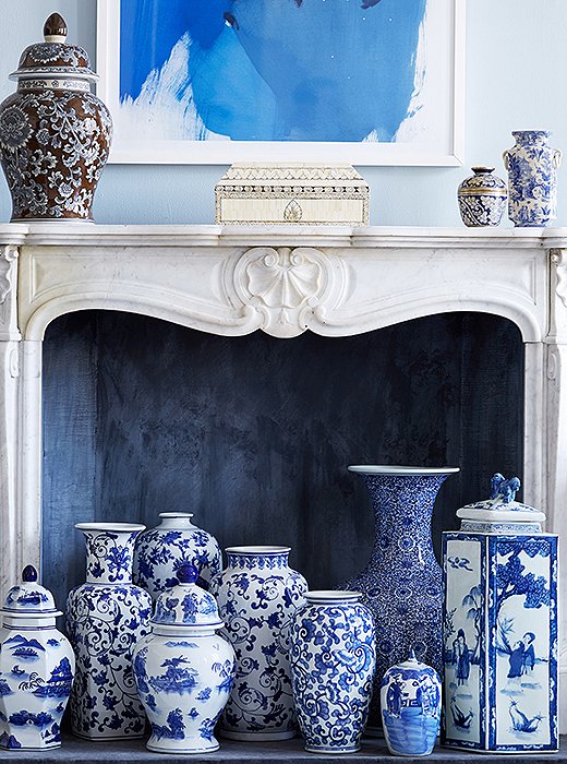 The fireplace is an ideal spot for showing off a collection, such as this medley of blue-and-white ginger jars. With varying heights, shapes, and patterns, they have more impact grouped together than they would scattered throughout the house. Photo by Manuel Rodriguez
