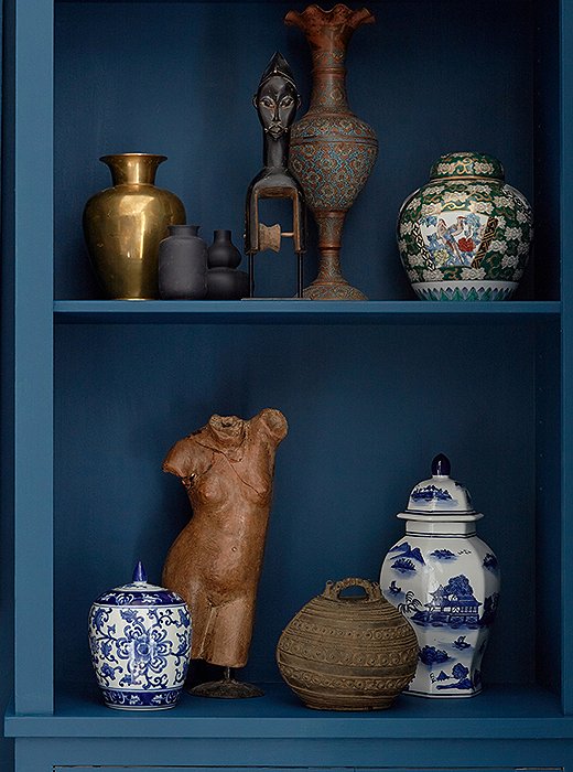 Michelle filled built-in bookshelves with a medley of worldly objets, giving her glamorous room a well-traveled vibe.
