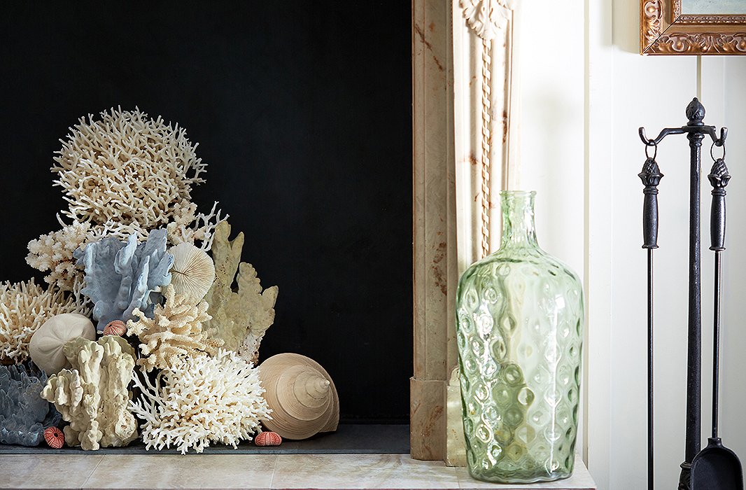 Let your fireplace have its moment in the sun with a beautifully beachy display of coral. Stick to one or two colors for a pulled-together look. Photo by Tony Vu
