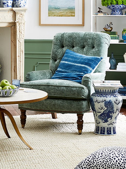 Indigo stripes add ease to a classic tufted armchair, upholstered in a soft sage green.
