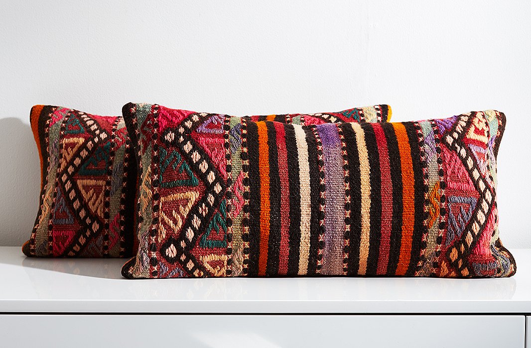 Woven on a loom to create a tight, flat weave, kilim rugs are often turned into upholstery for pillows and other furnishings.
