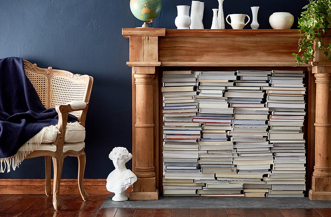 An ideal marriage of style and function, this fireplace display frees up major bookshelf space while creating a cozy, eclectic vibe. Turn the spines to the side for a more uniform look. Photo by Tony Vu
