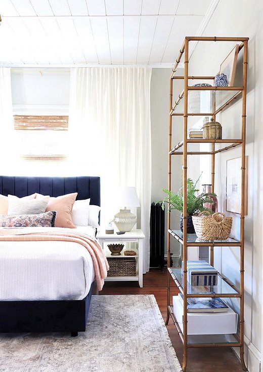 Carli opted  to bring in a dash of color in the main bedroom. The navy channeled bed serves as a nice background for the pops of pink.
