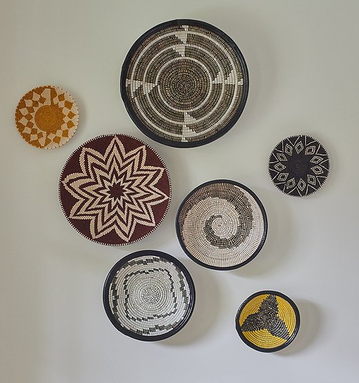 The homeowners placed art collected from their travels throughout the house. Kelly grouped these decorative bowls together to “keep the place from feeling too sterile.”
