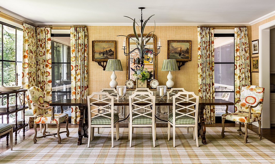 Pattern on pattern is the name of the game in this lakeside home. The plaid rug served as the base for this room. James pulled colors for the upholstery, curtains, and raffia wall covering from the rug’s soft tones.
