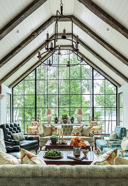 A panoramic view is the star of this living room. Soft blues and greens reflect the ease of lakeside living and the colors of nature.
