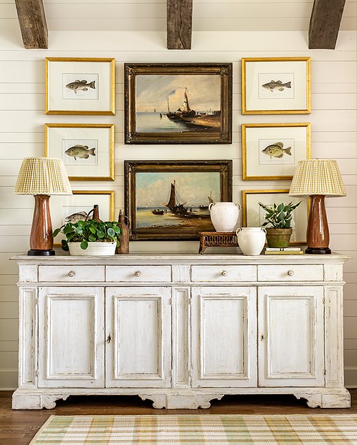 The casual elegance of the framed fish paintings point to the home’s proximity near the water in a classic way.
