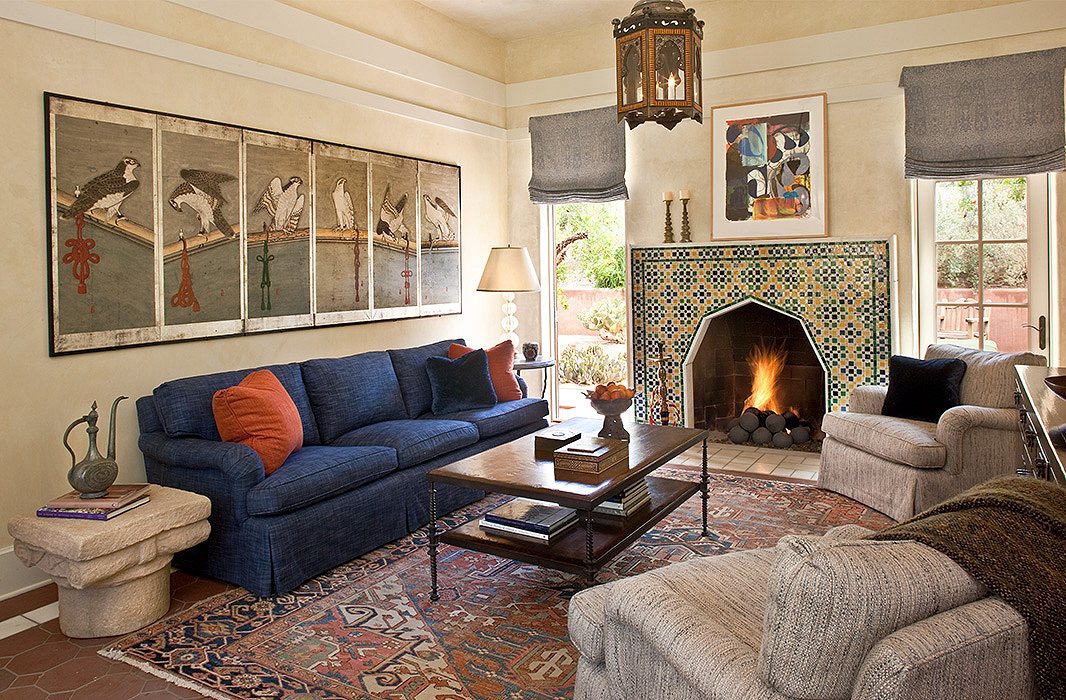 A worldly mix of art and textiles makes for an inviting seating area. 
