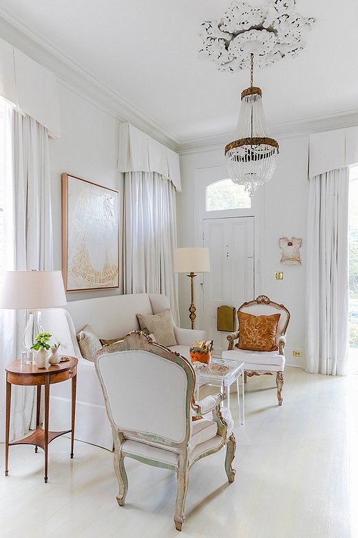 An embellished ceiling medallion paired with a beaded crystal chandelier makes a striking statement in a sitting room. Find a similar chandelier here.
