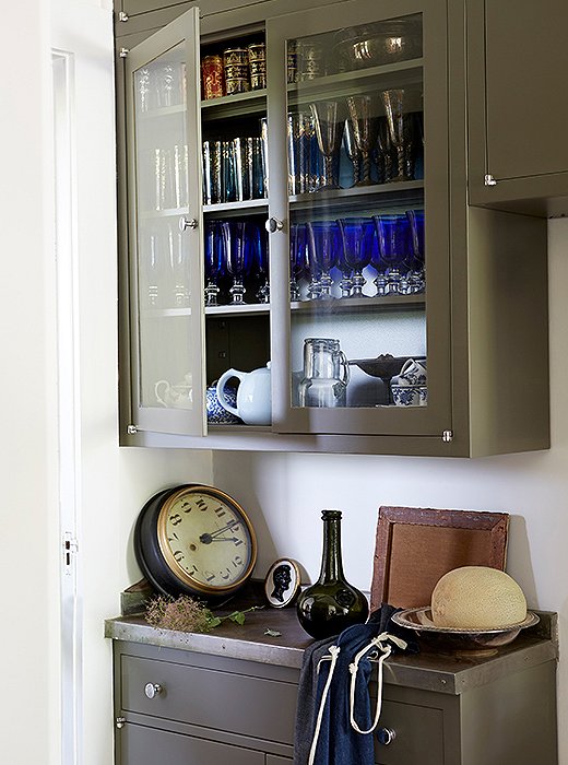 Cabinets in the butler’s pantry house the couple’s collection of vintage glassware and a trio of teapots.
