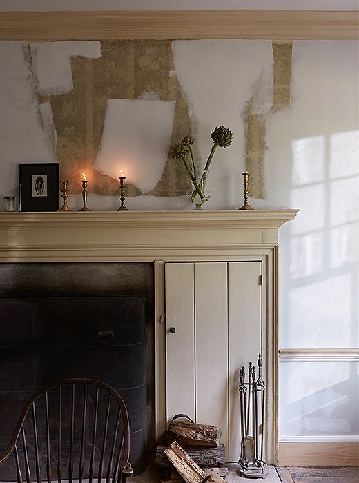 Beauty in progress: Candlelight flickers against partially primed walls in the dining room.
