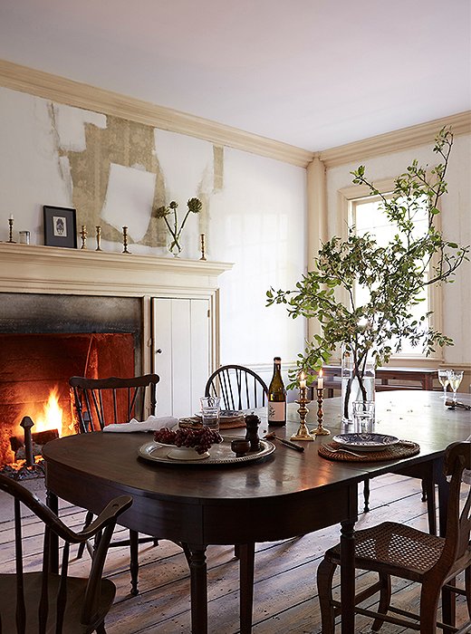 In the dining room, a table scored at an antiques store in nearby Chatham can be taken apart to form a smaller table and a pair of consoles.
