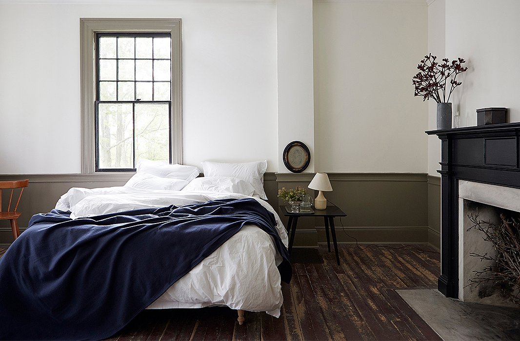 A navy Faribault blanket complements crisp white pillowcases and a heavenly duvet cover by Matteo in one of the guest suites. Frank sourced the bedding (and the vintage Paul McCobb side table) on One Kings Lane.
