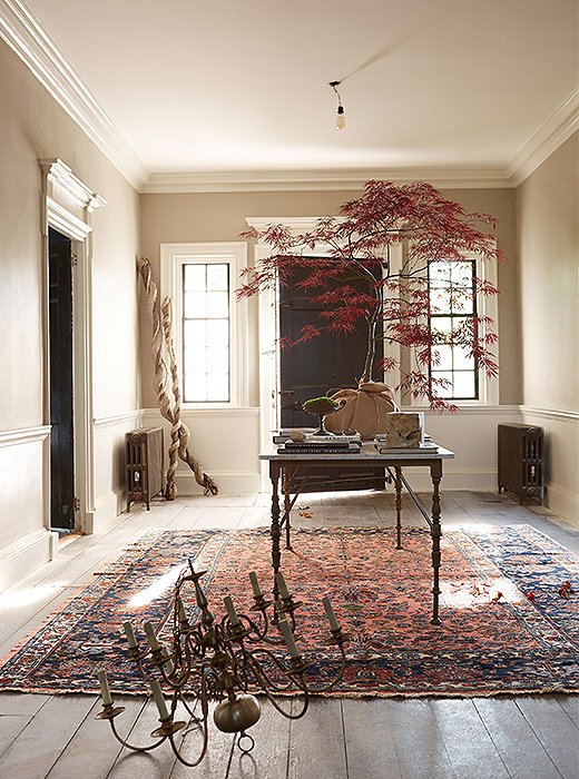 An antique Dutch chandelier sits in front of a vintage marble-top table, both lucky finds from local dealers. The rug, also vintage, came from One Kings Lane.
